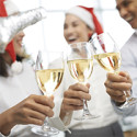 Close-up image of colleagues clinking glasses at Christmas party